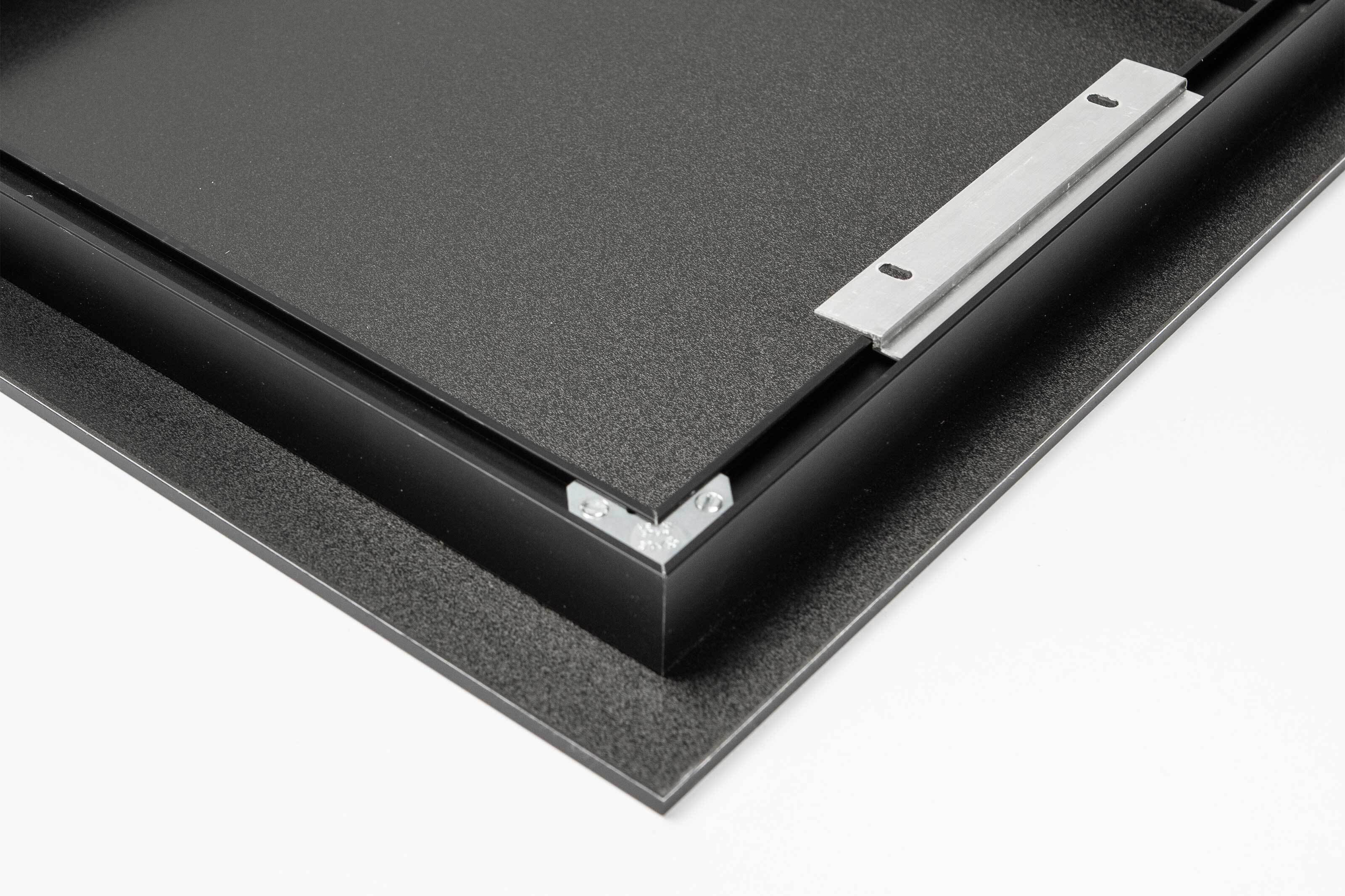 back of an acrylic print with an inset metal frame with metal hanging cleat