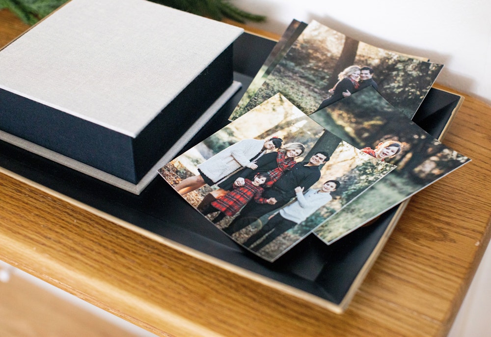 Loose prints on side table next to fabric cover Image Box