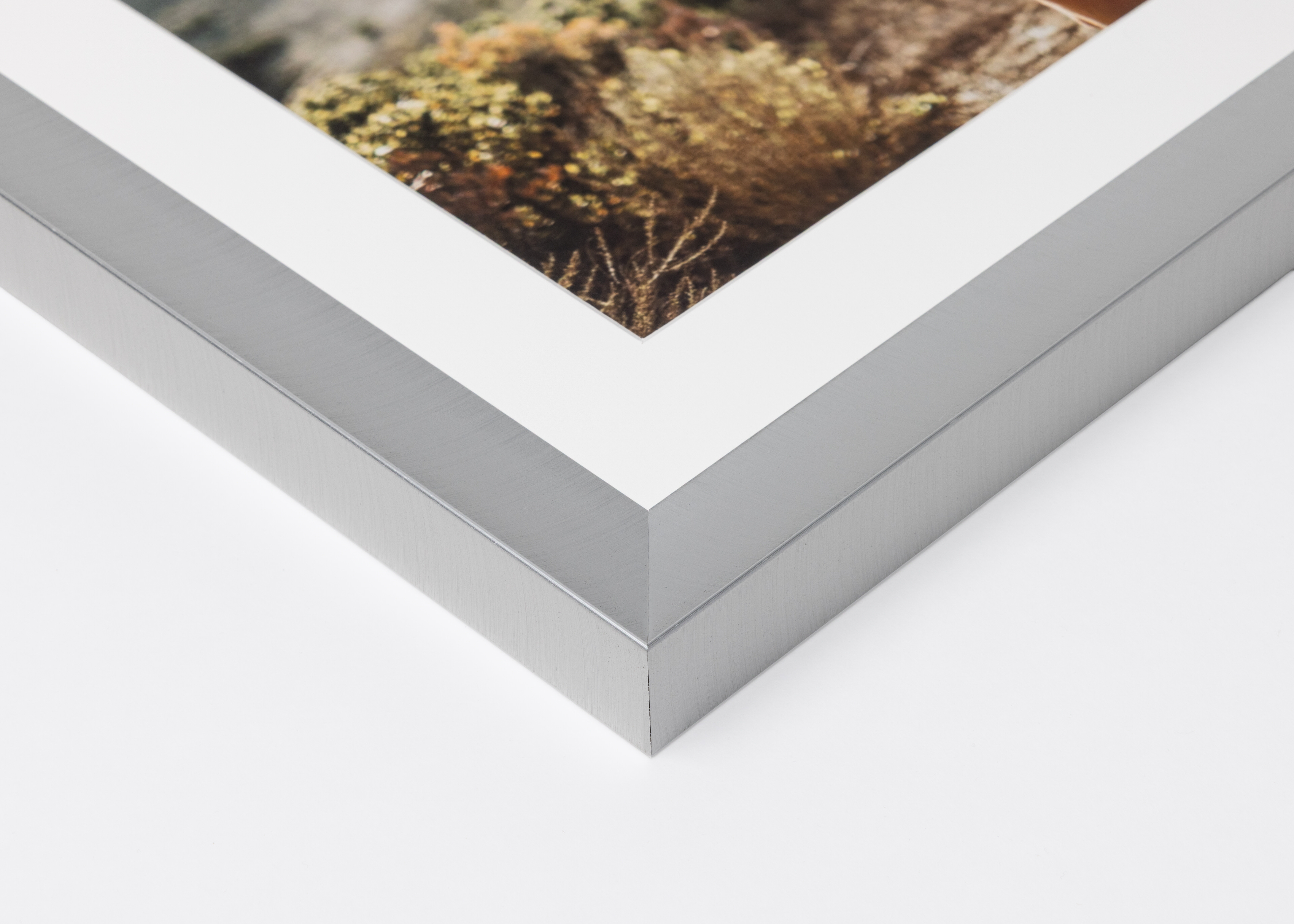 Close-up corner of a Pewter Metal Framed Print moulding on a white background