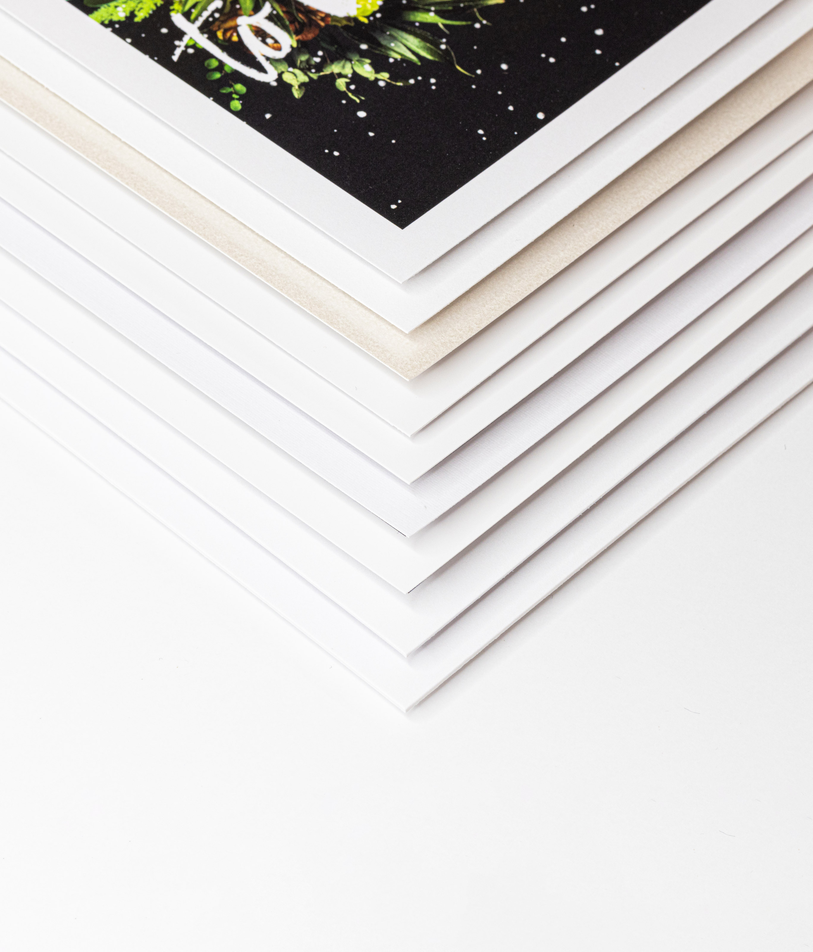 Detail of nine press paper options stacked with corner of each shown on a white background