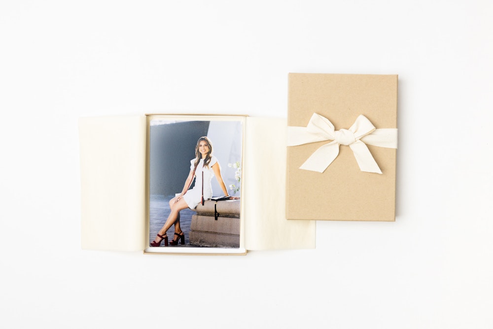 Cover and inside of Kraft with Cream Ribbon Premium Packaging box holding senior portrait Photo Prints on white background.