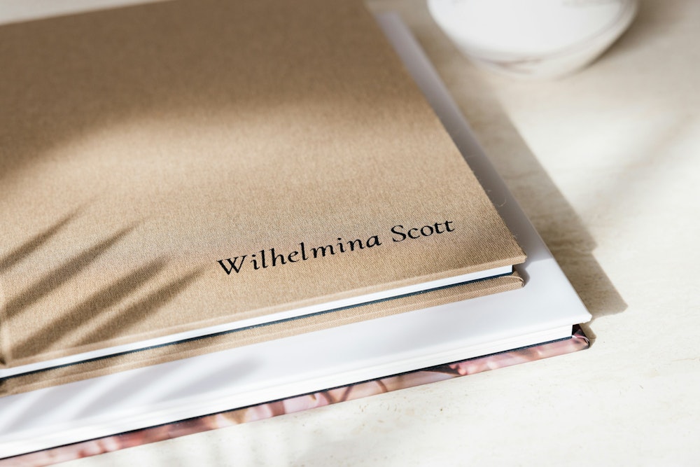 A WHCC Senior Photo Book with a tan bookcloth fabric and debossed cover