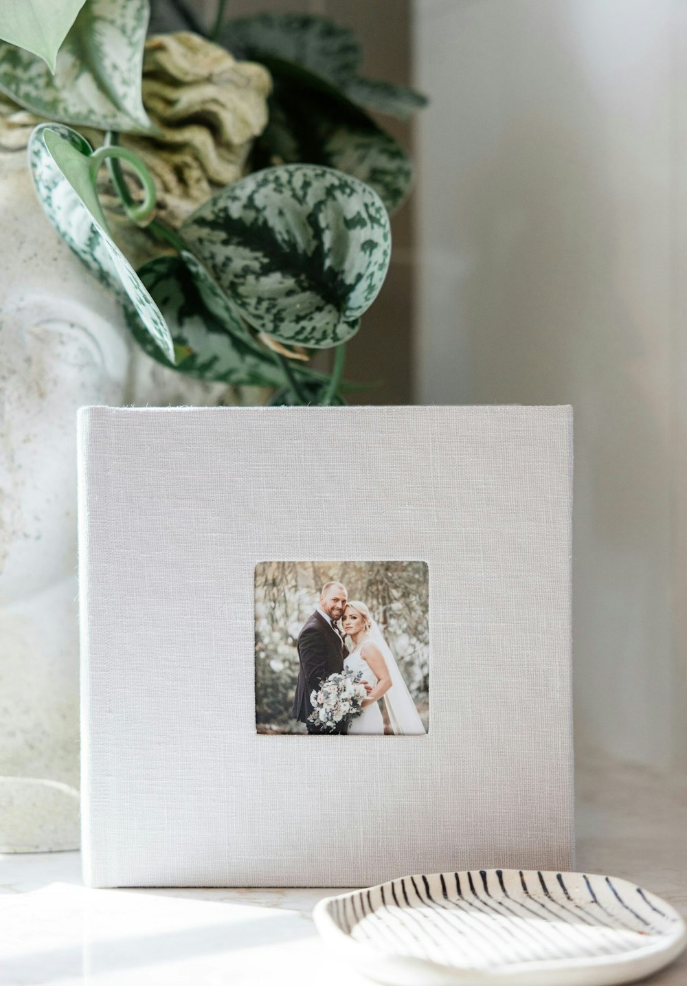 WHCC wedding Photo Album with a Linen Cameo Cover sitting upright on a shelf.