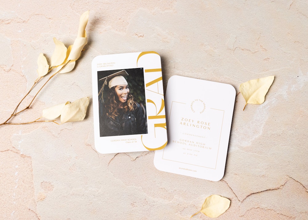 Two elegant wedding invitations on a textured surface, complemented by golden leaves. one card features a photo of a smiling woman, while the other displays event details with stylish graphics.