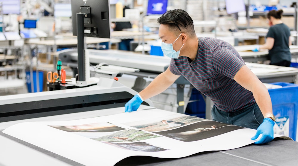Staff prepping Fine Art Prints production cutting table