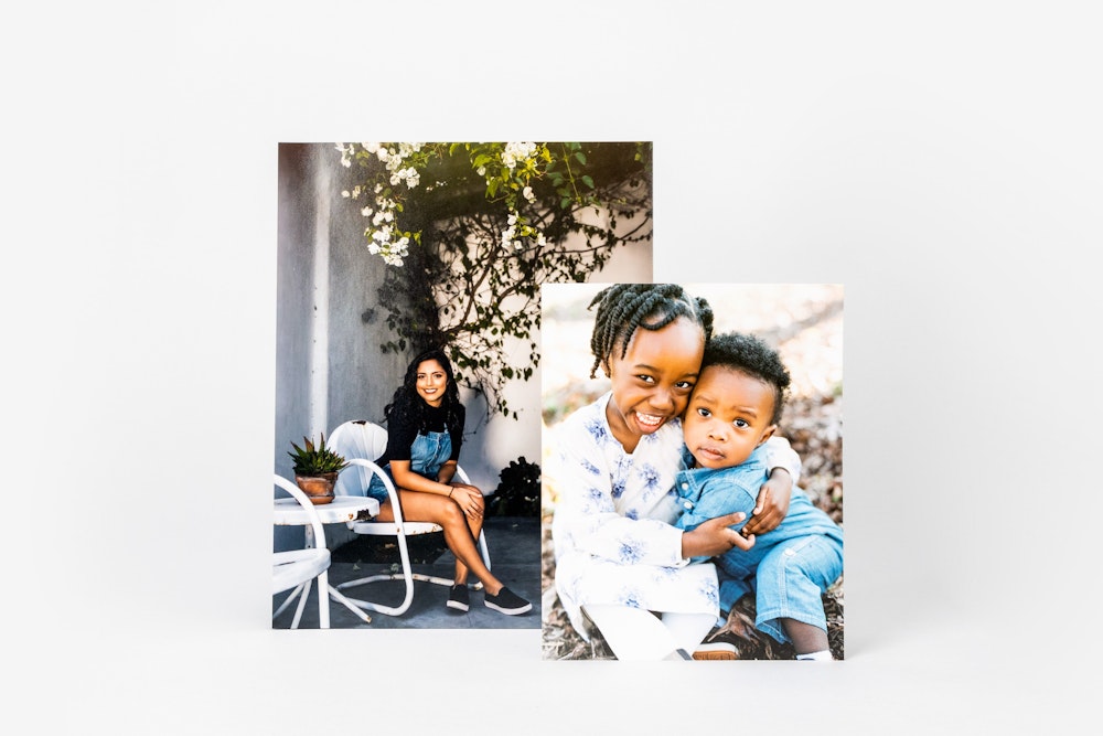 Two Photographic Prints: one of a seated woman outdoors, and another of a smiling child hugging a younger child, both set in an outdoor setting.