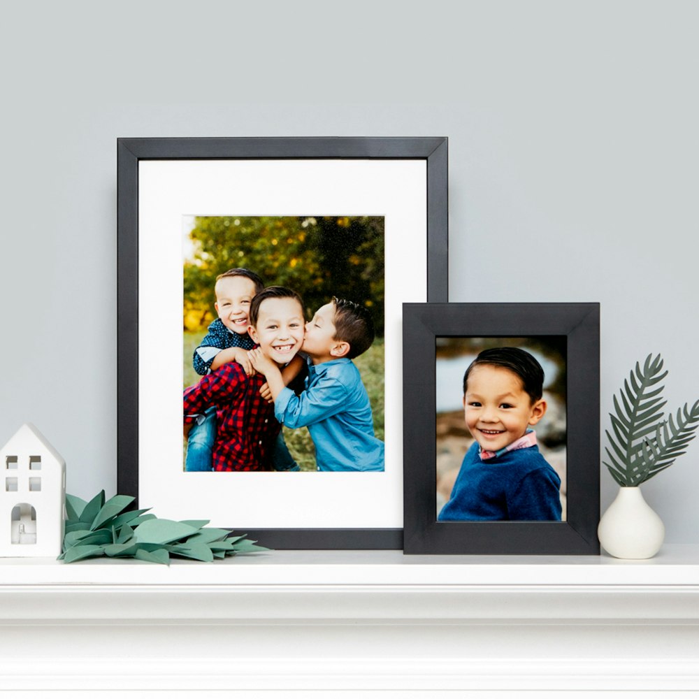 Whcc layered black framed prints on mantle