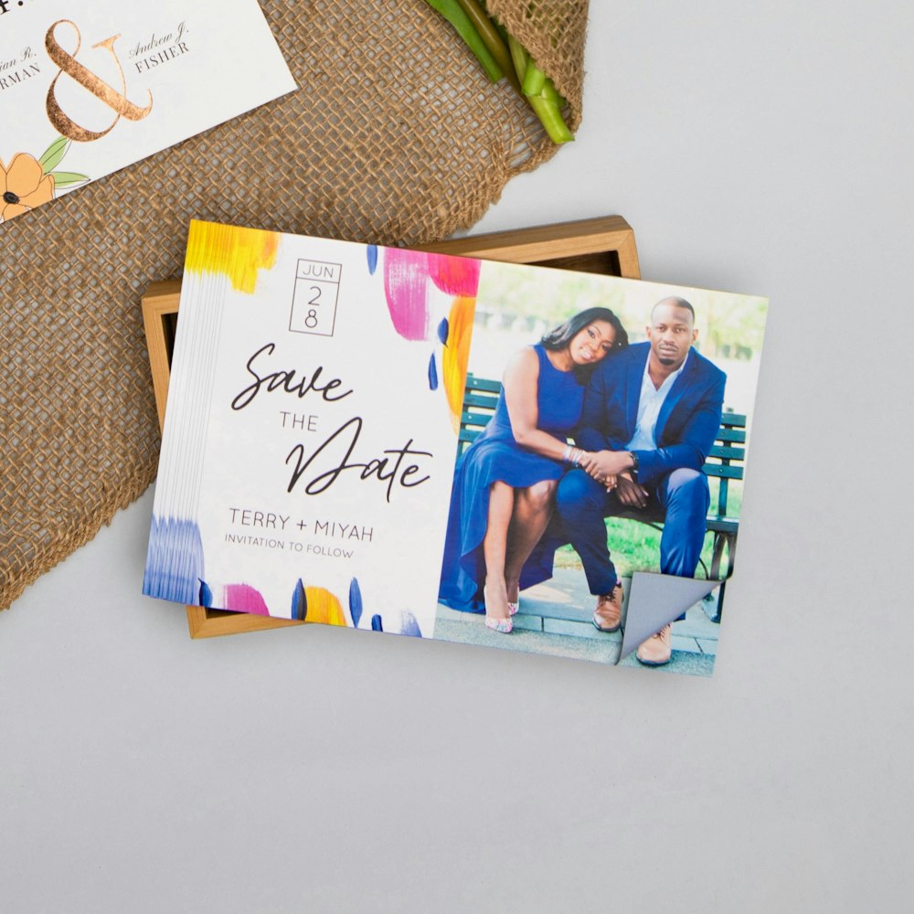 Stack of Magnet save the date cards on wood box
