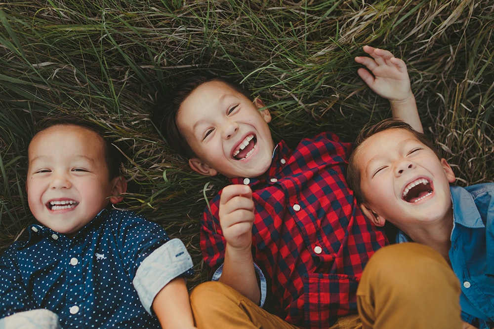 Whcc timms family kids laughing laying on ground